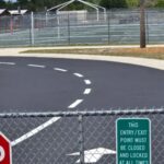 School parking lot with fresh sealcoat and crisp white striping