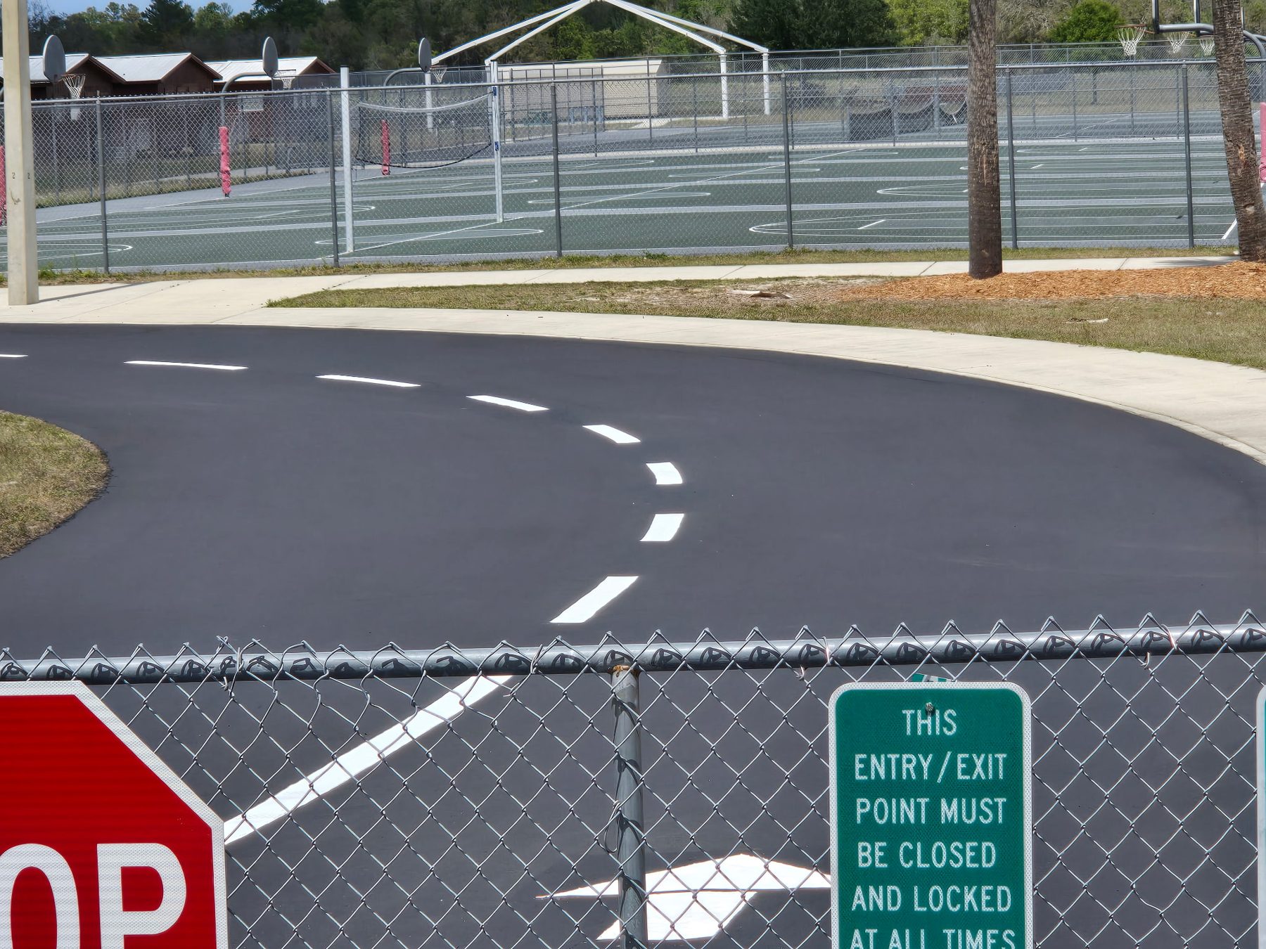 School parking lot with fresh sealcoat and crisp white striping