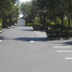Newly sealcoated commercial drive aisle with fresh striping