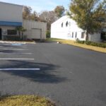Fresh black sealcoat and sharp white stripes at a church parking lot